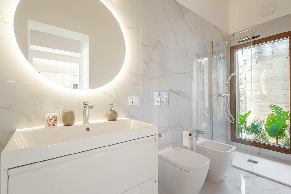 Marble bathroom with backlit mirror